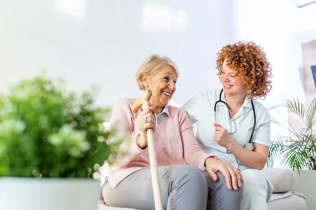 Older adult and family member reviewing care options at a table with notes and a medical folder.